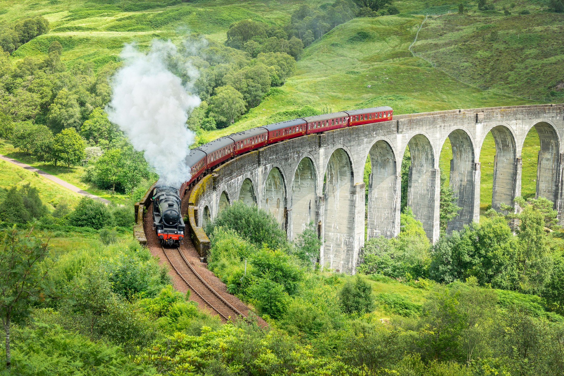 The Jacobite steam train on Glenfinnan viaduct in North West Highlands, Scotland, UK. The train and the bridge have been featured in the Harry Potter films.
